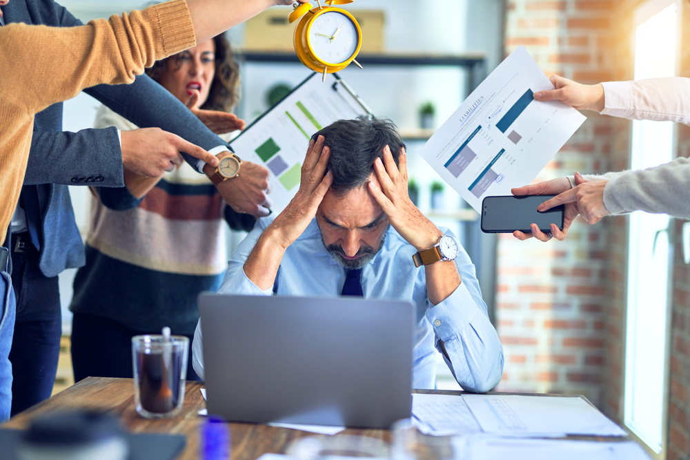 Group of business workers working together. Partners stressing one of them at the office