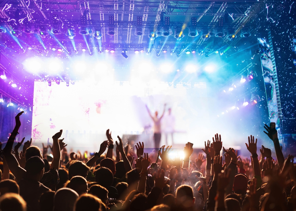 crowd partying stage lights live concert summer music festival
